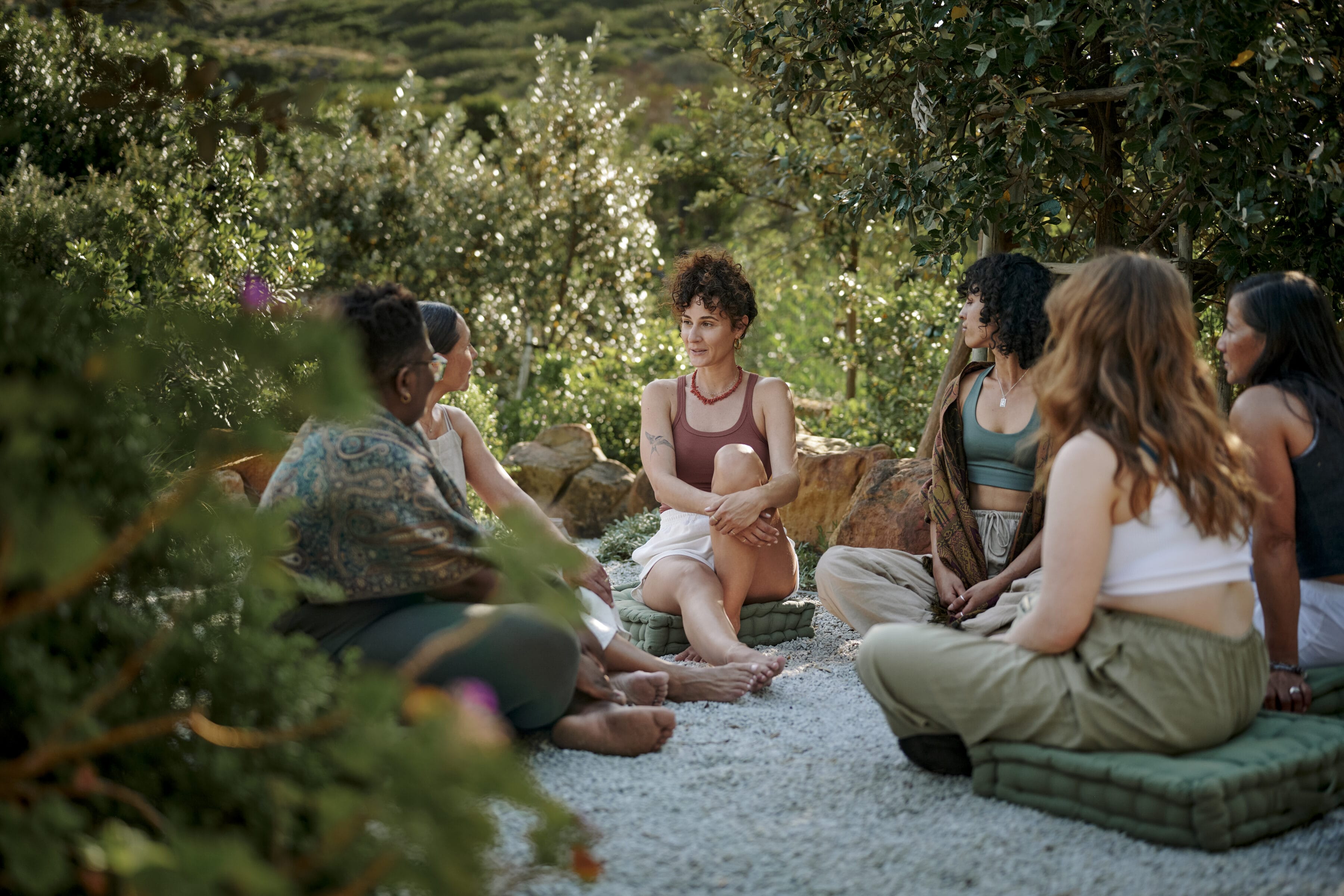 Photo of a group of women seated outside at a retreat