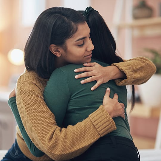 Photo of two women hugging