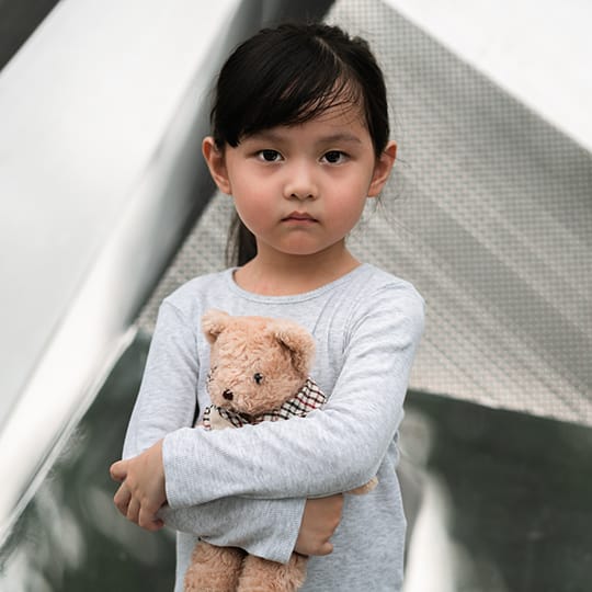 Photo of a little girl holding a teddy bear