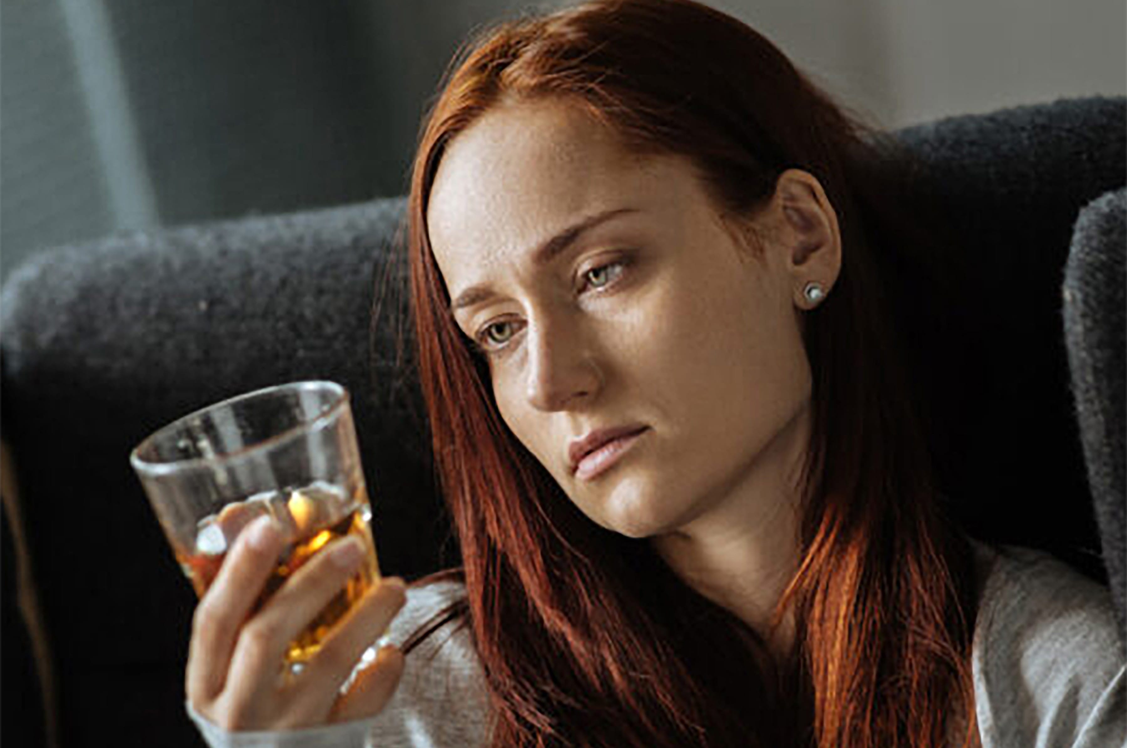 Photo of a woman holding an alcoholic drink